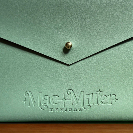 Sage leather card clutch with 'Mac Miller' logo embossed 
