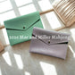 Two leather card clutches, one sage and one lavender