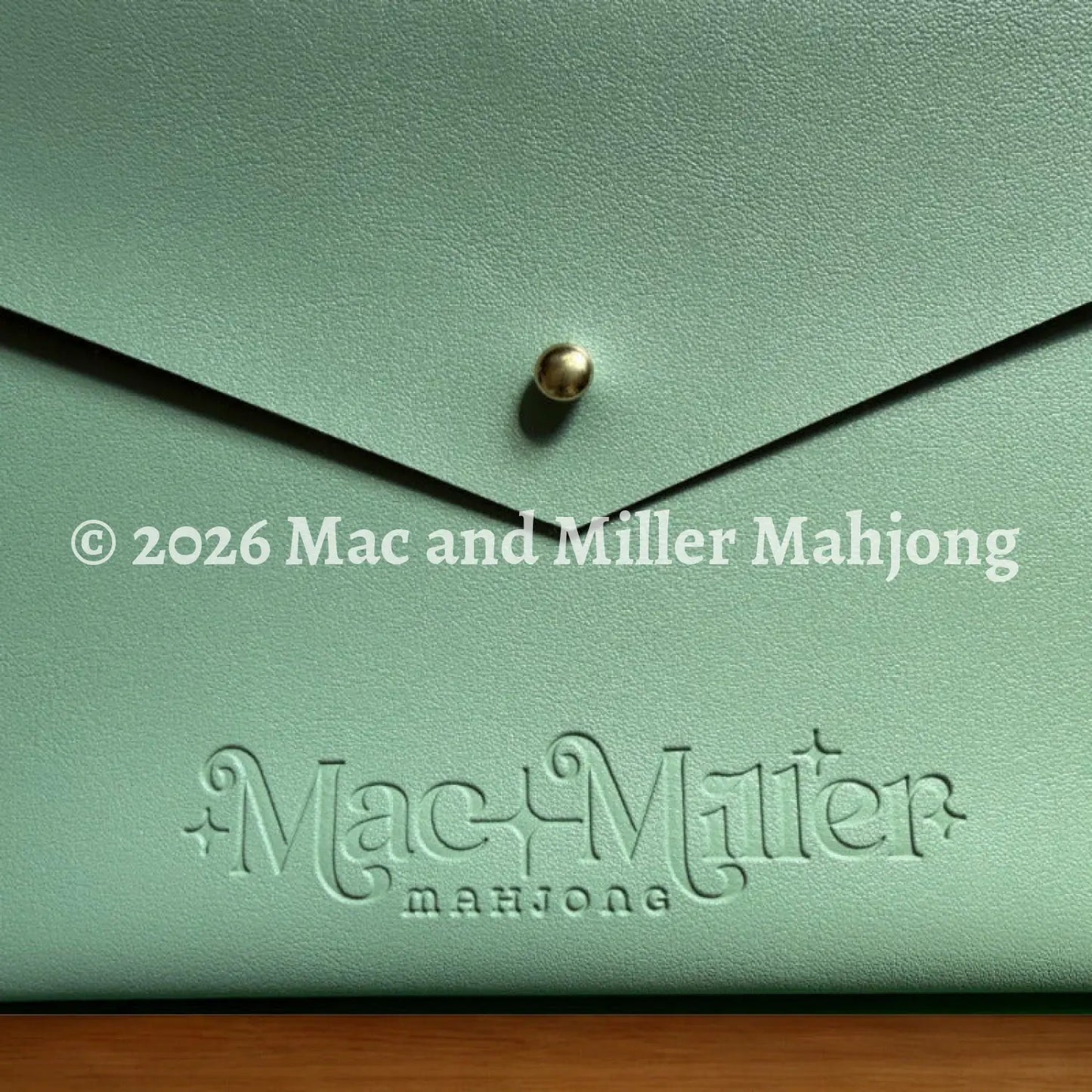 Sage leather card clutch with 'Mac Miller' logo embossed 