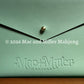 Sage leather card clutch with 'Mac Miller' logo embossed 